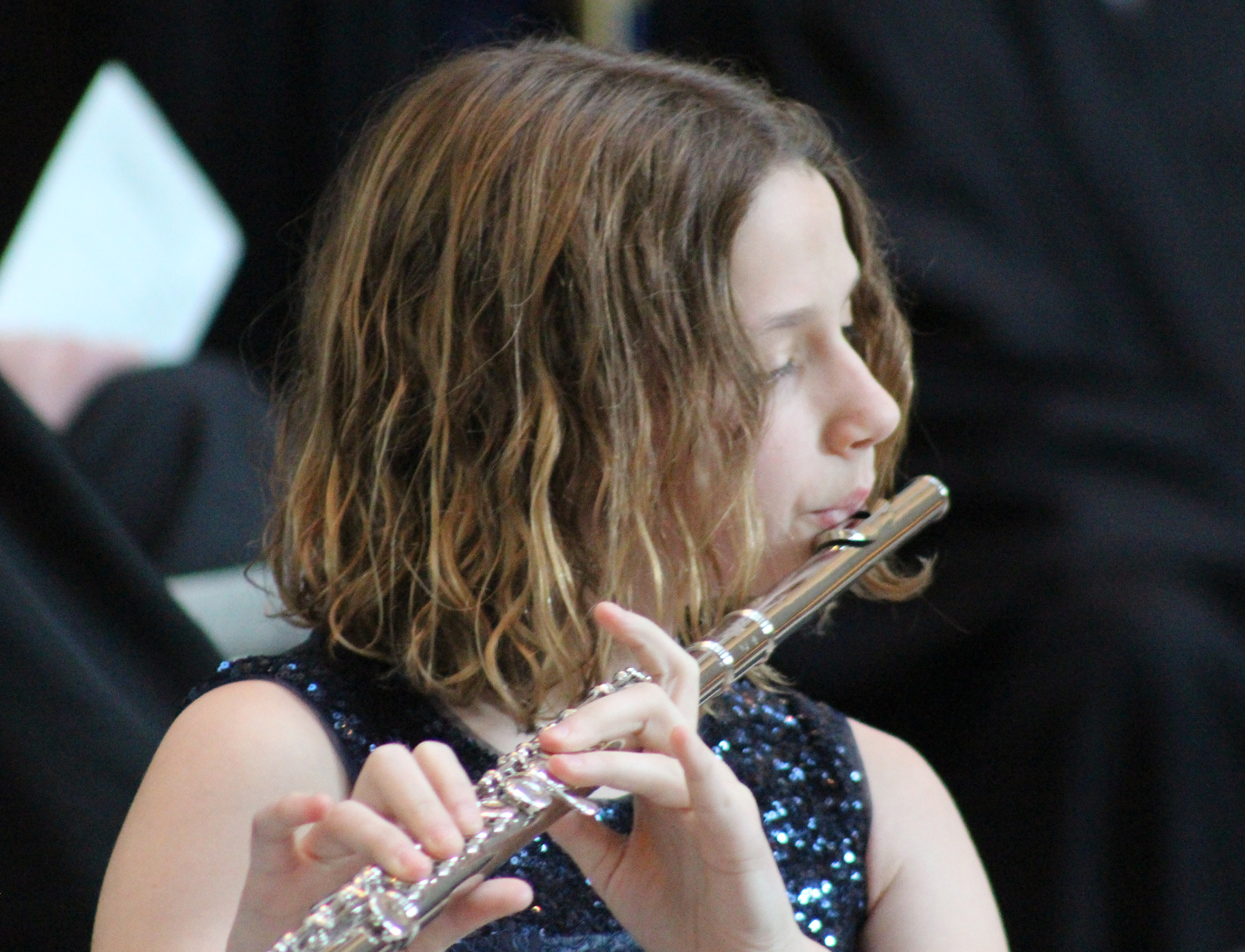 Elizabeth Buescher plays the flute at her father&#039;s investiture ceremony at the Hruska Federal Courthouse on Friday, Nov. 15, 2019. (Photo by Scott Stewart)