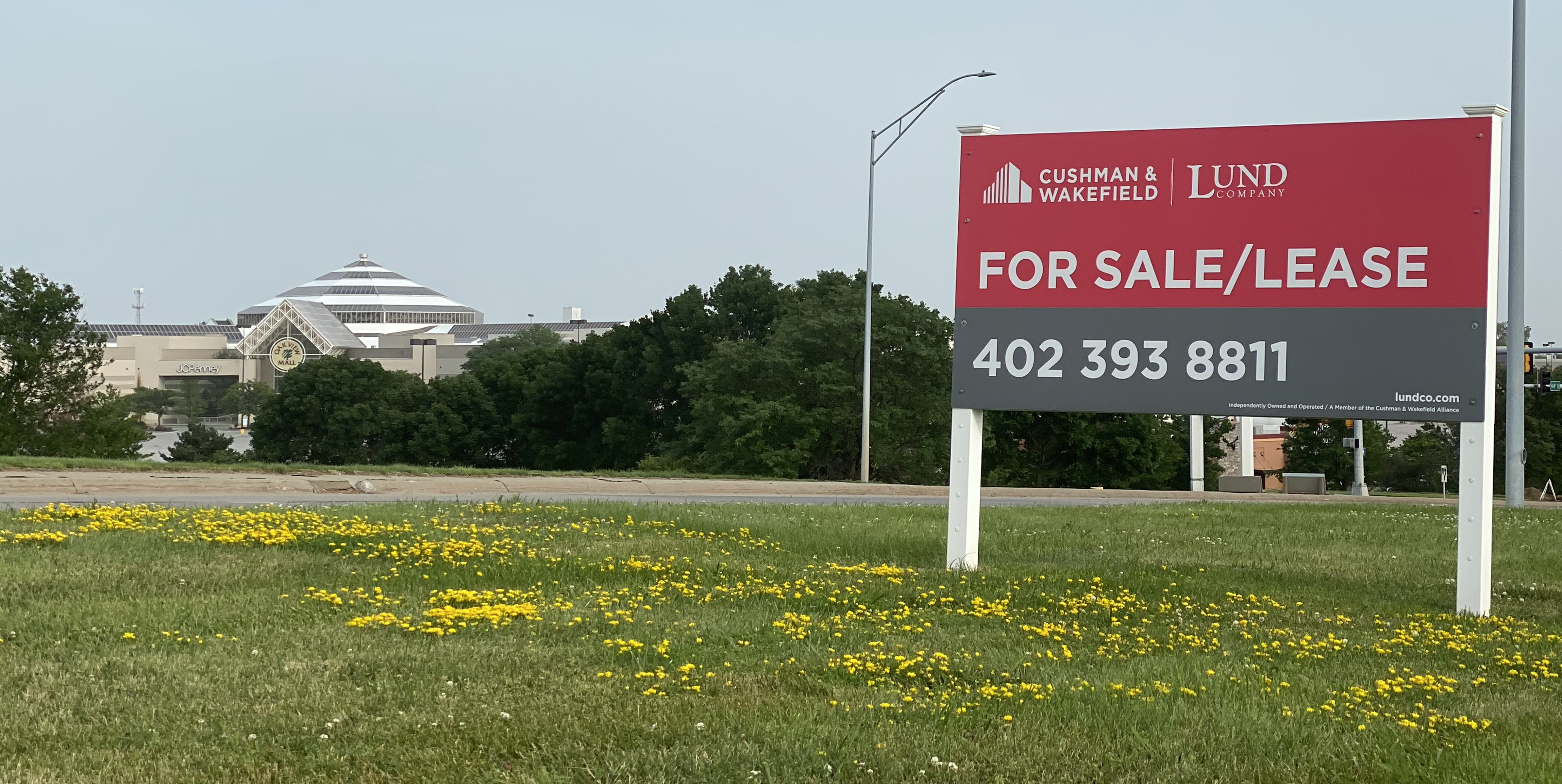 At right, a for sale or lease sign sits outside the Shopko property with Oakview Mall in the distance, which has other commercial real estate properties available for redevelopment. (Scott Stewart)