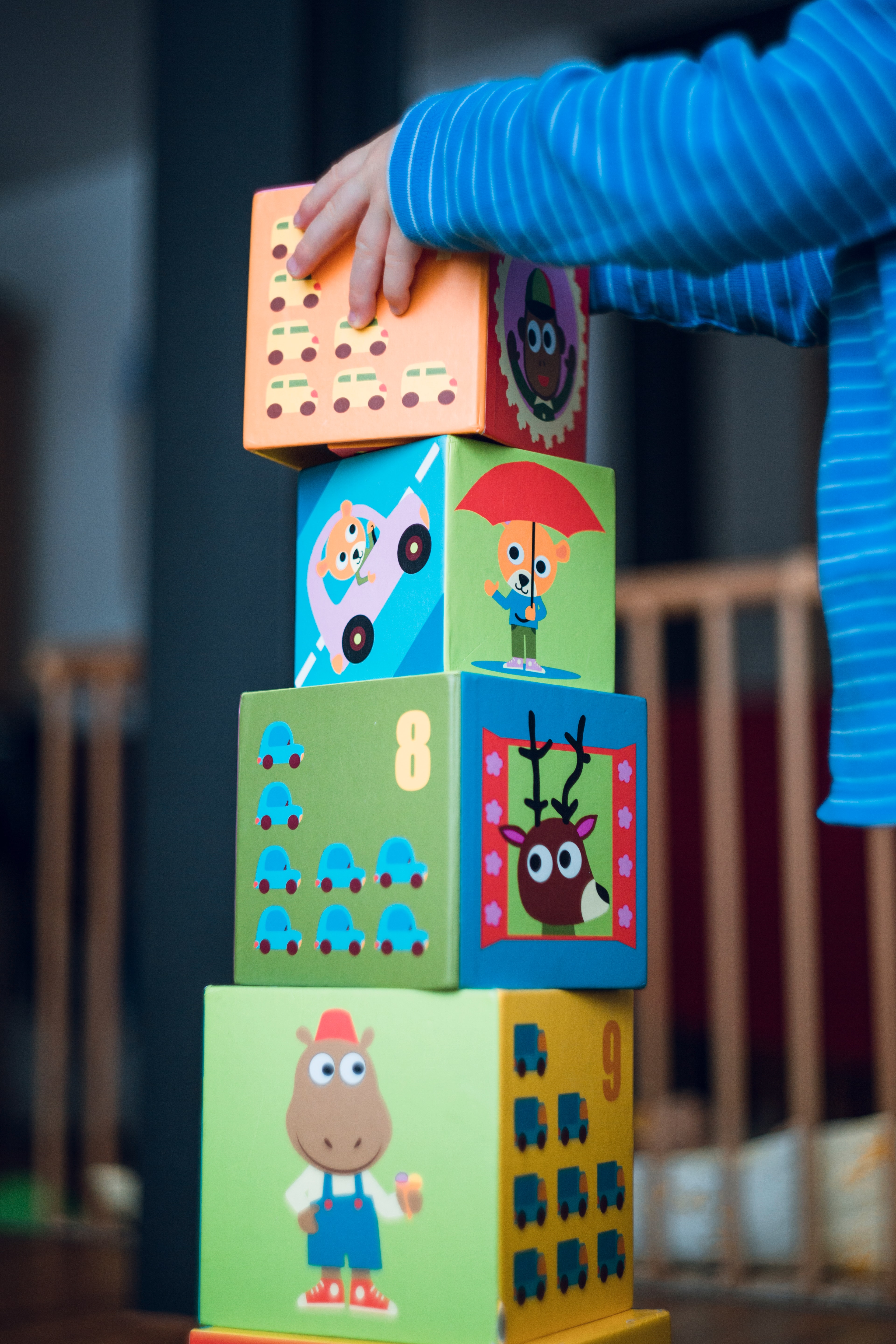 A young boy stacks cardboard boxes. States are looking at how they can use federal dollars to transform an industry that has been neglected for decades. (Markus Spiske via Unsplash)