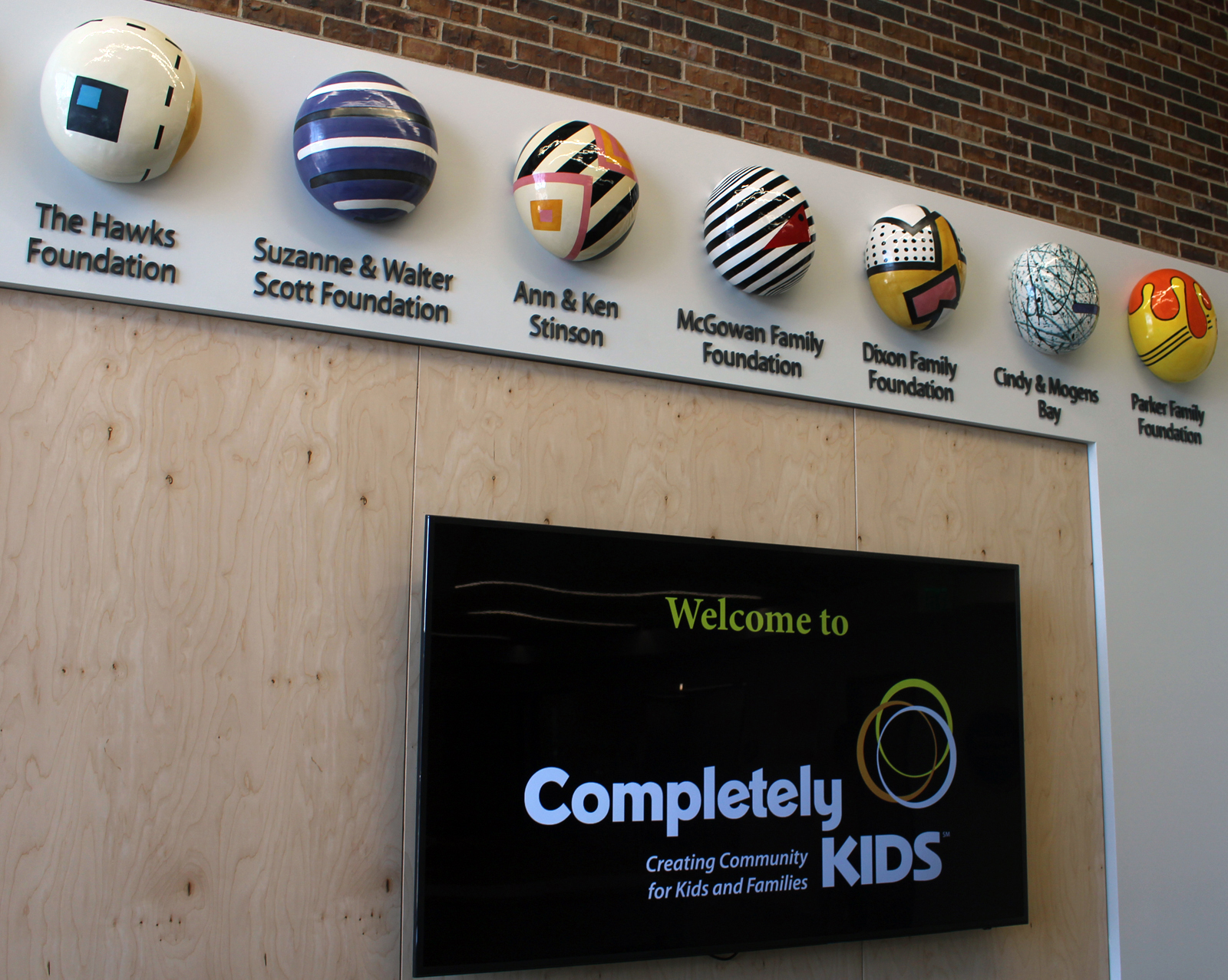 Major donors to the $10 million Completely KIDS capital campaign for its new headquarters space are recognized with artistic “jellybeans” in the main entrance to the facility at 2566 St. Mary’s Ave. (Photo by Scott Stewart)