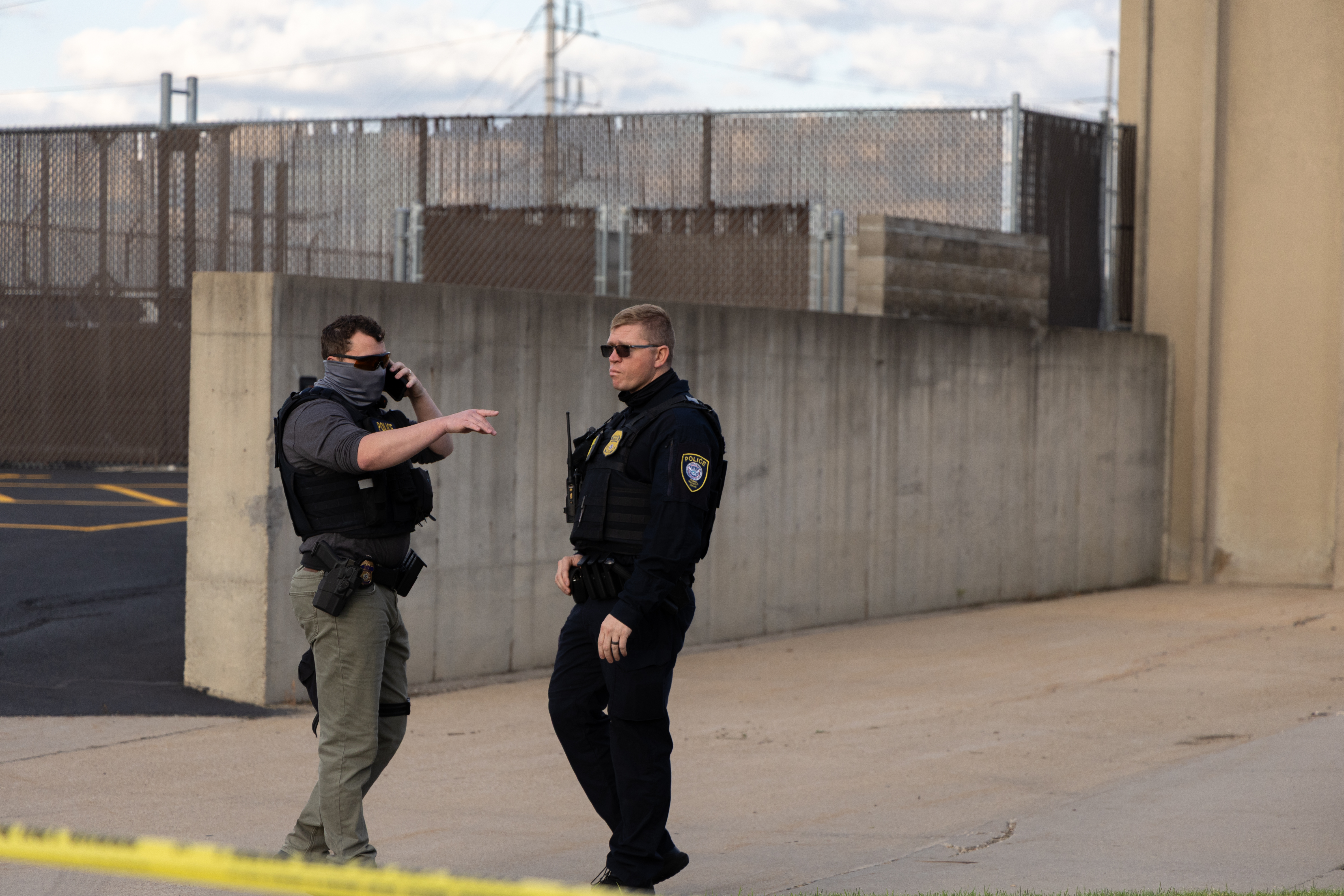 Two federal officers stand outside the Cedar Rapids ICE Field Office during a rally on Tuesday, Sept. 2, 2025, in Cedar Rapids, Iowa. Neither the Cedar Rapids Police Department nor the Linn County Sheriff&#039;s Office has a 287(g) agreement with Immigration and Customs Enforcement. However, the Iowa State Patrol does.<br />(Naomi Delkamiller / The Midwest Newsroom)