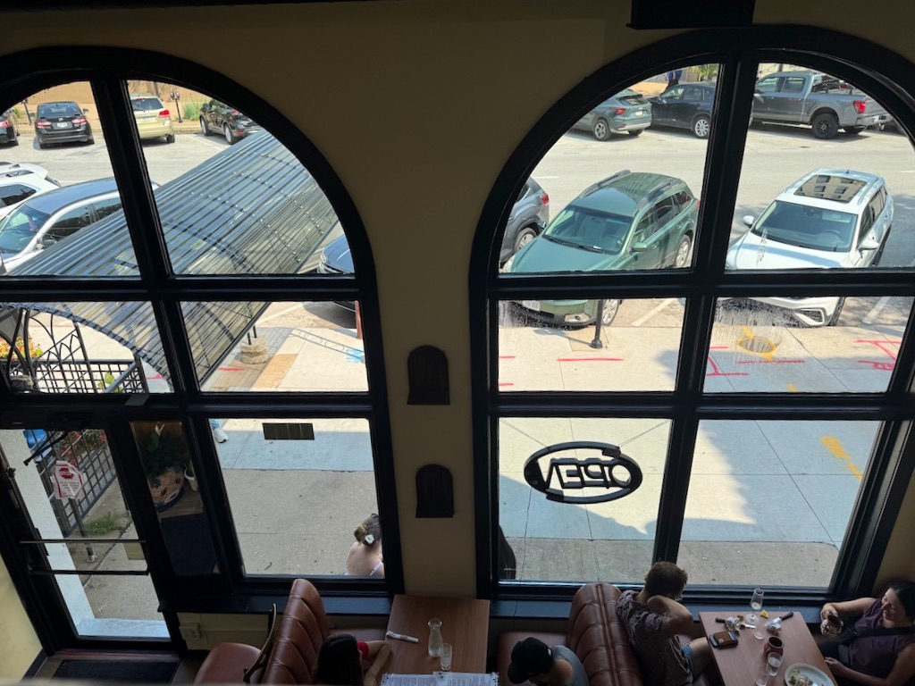 The two-story dining room at Flora Cafe affords a view of Farnam Street.<br />(Sarah Baker Hansen / Flatwater Free Press)