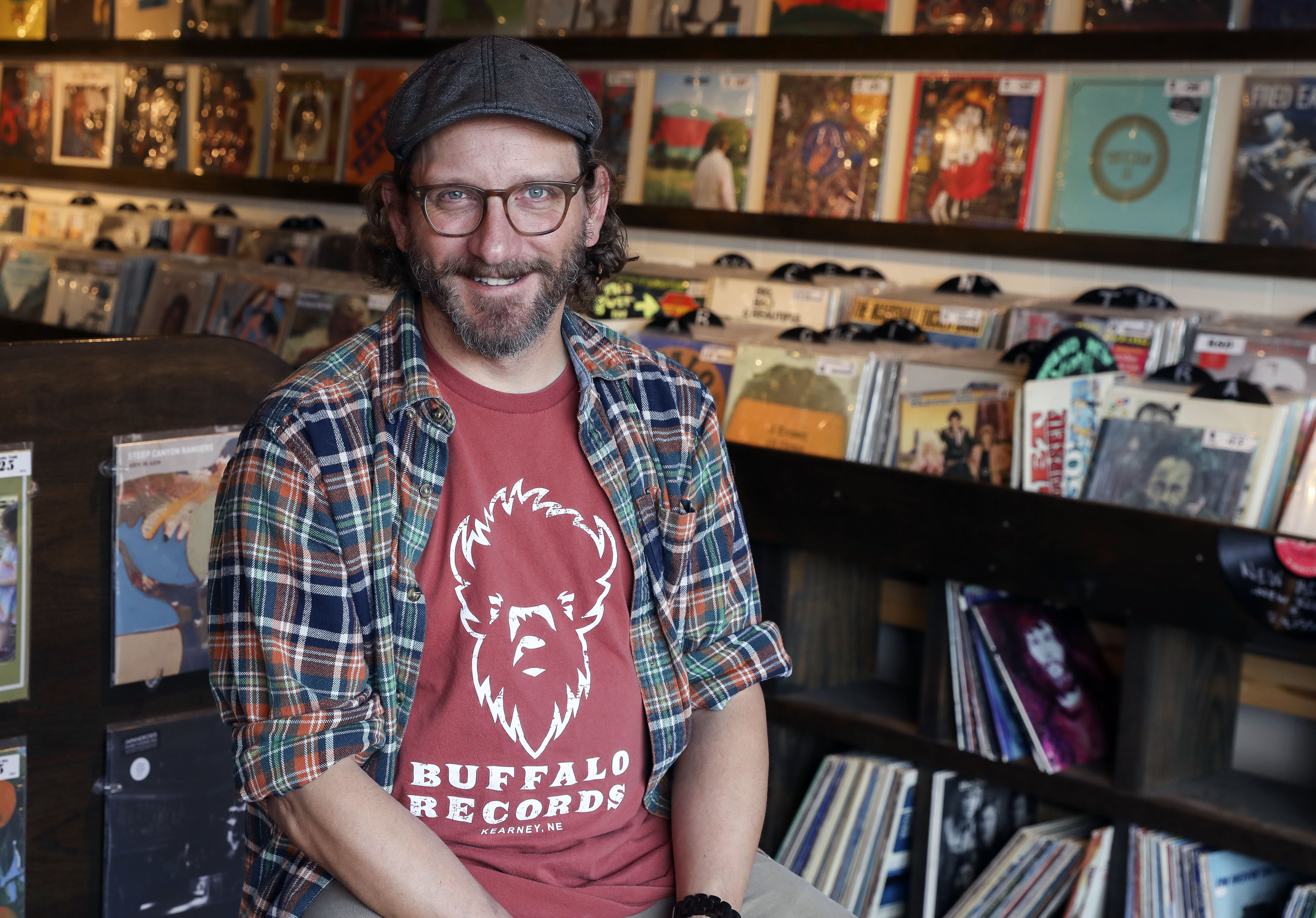 Buffalo Records co-owner Bryce Jensen poses for a photo, Wednesday, Oct. 21, 2020 in Kearney, Neb. Vinyl record sales have made a comeback nationally, and Buffalo Records co-owner Bryce Jensen is proud that his Kearney business is a part of that resurgence. (Ericka Pritchard/Kearney Hub via AP)