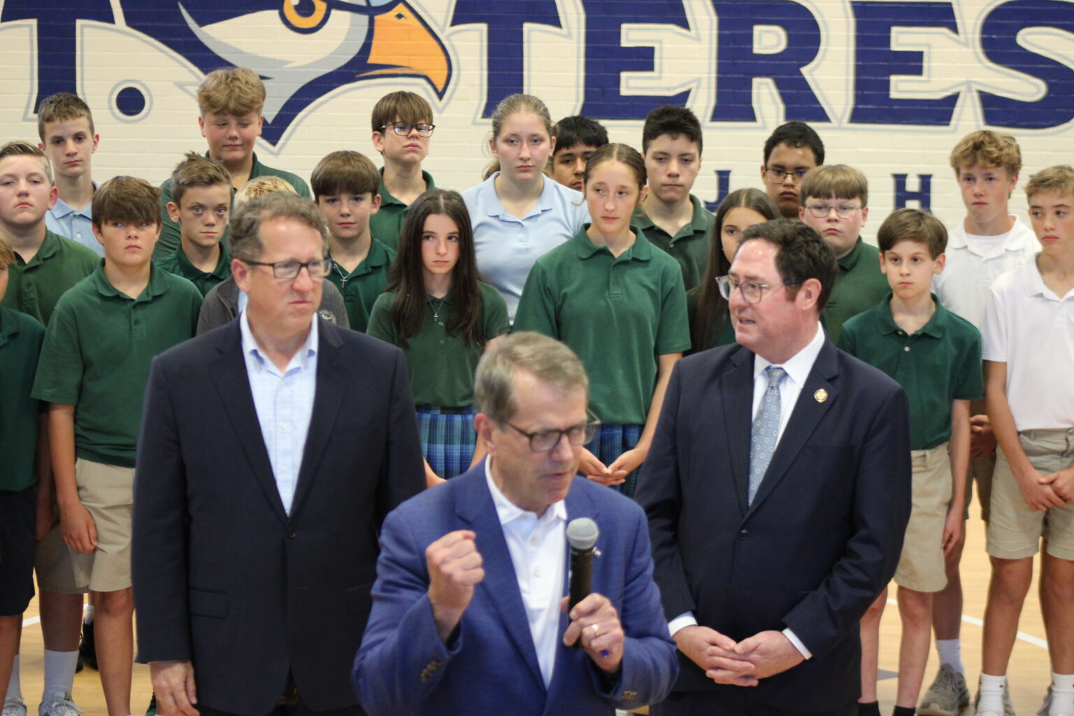 Nebraska Gov. Jim Pillen talking in front of U.S. Reps. Adrian Smith and Mike Flood at St. Teresa Catholic School in Lincoln on Sep. 29, 2025.<br />(Juan Salinas II / Nebraska Examiner)