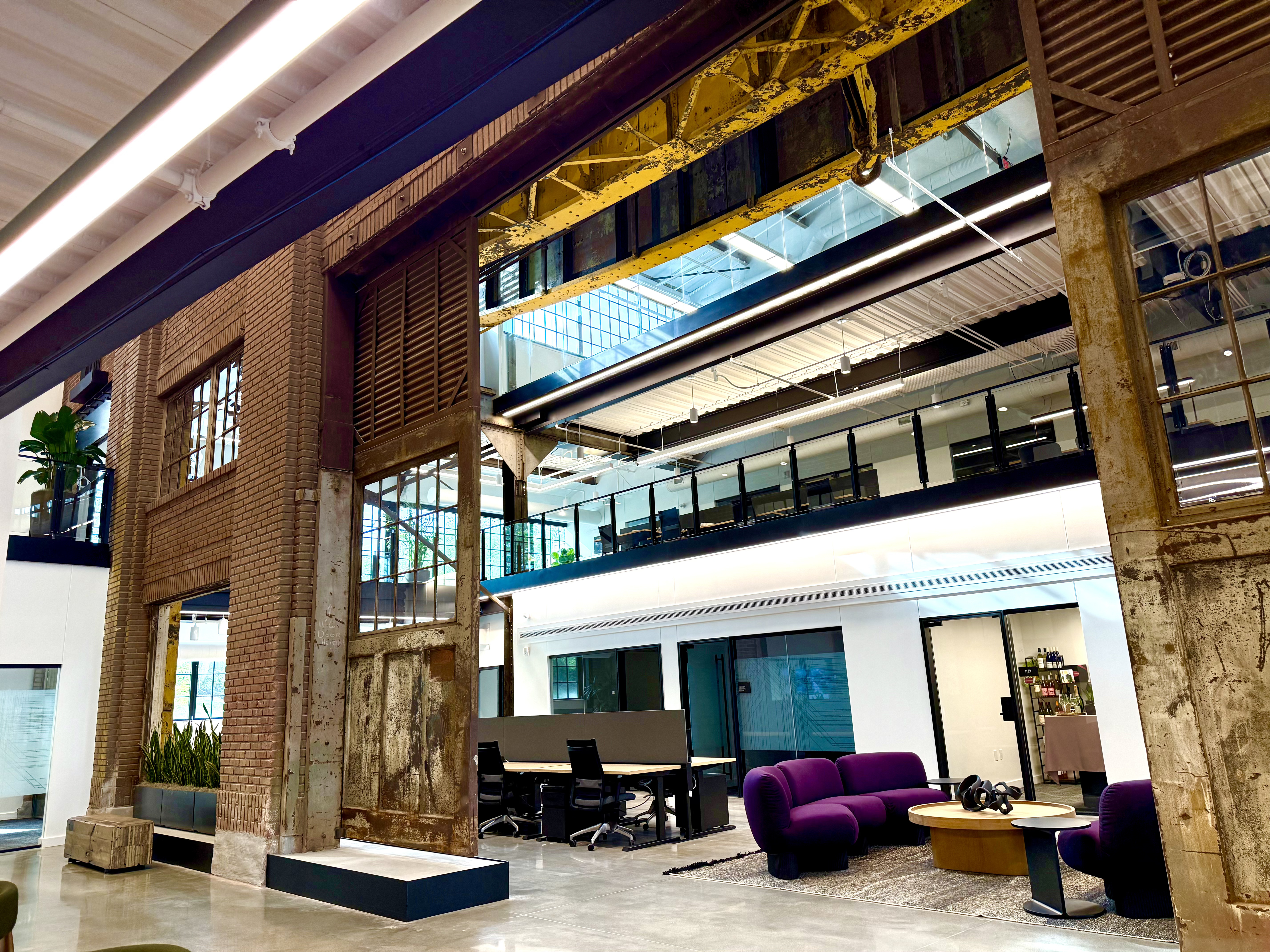 A section of the Catalyst that features desk areas and smaller offices for lease. Above is the gantry crane that used to move steel around in the plant.<br />(Cindy Gonzalez / Nebraska Examiner)