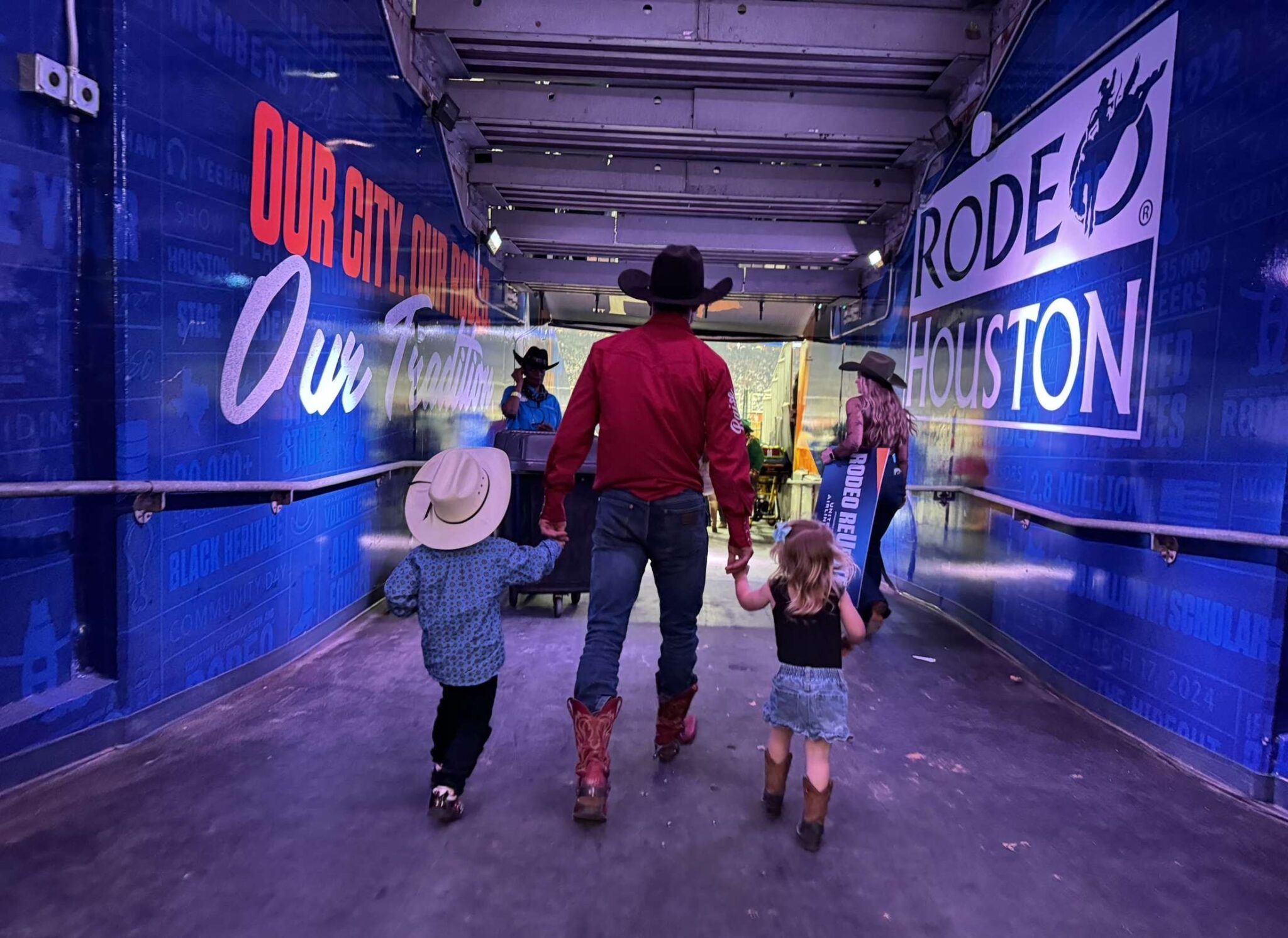 Bareback rider Garrett Shadbolt, of Merriman, Neb., walking into Rodeo Houston with two of his greatest fans, son George and daughter Mavis, by his side.<br />(Courtesy photo)