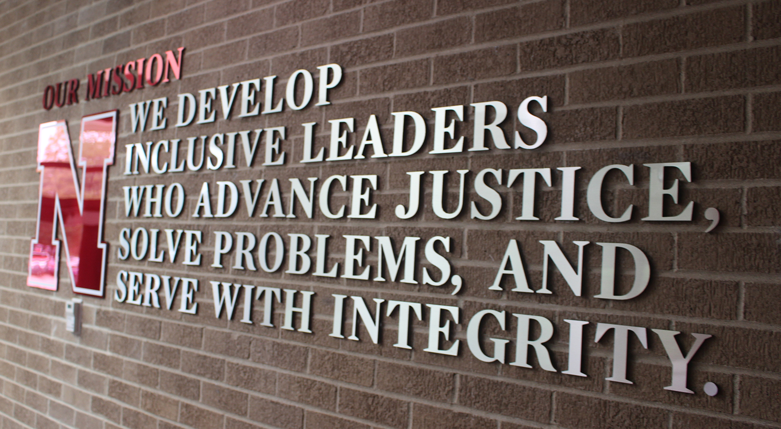 The new mission statement for Nebraska Law hangs by the entrance to McCollum Hall. (Photo by Scott Stewart)