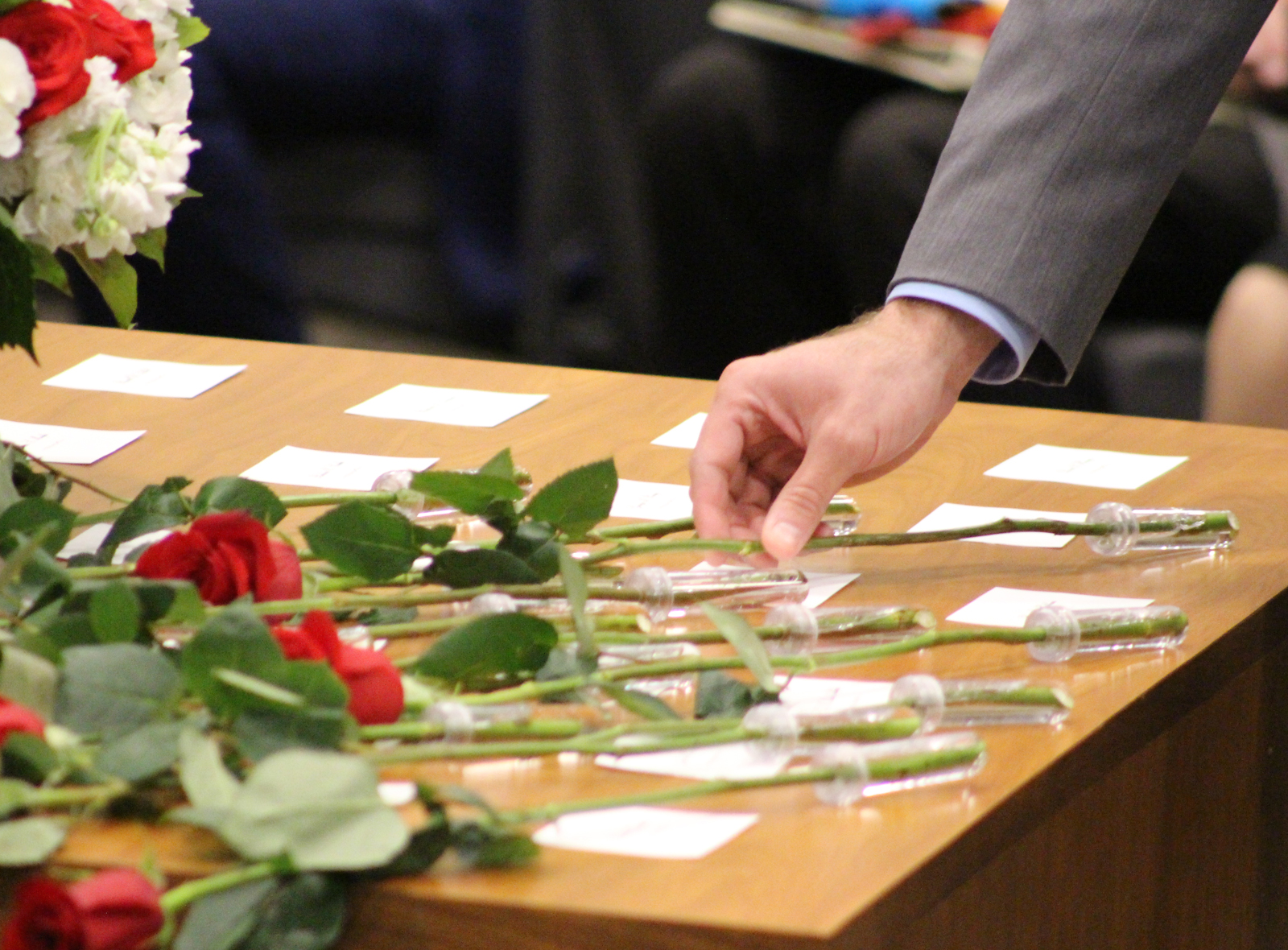 A rose is placed next to the name of an attorney who passed away in 2018-19 during the recognition of the absent at the Omaha Bar Association’s annual Memorial Day Program in the legislative chamber of the Omaha-Douglas Civic Center on May 10, 2019. (Photo by Scott Stewart)