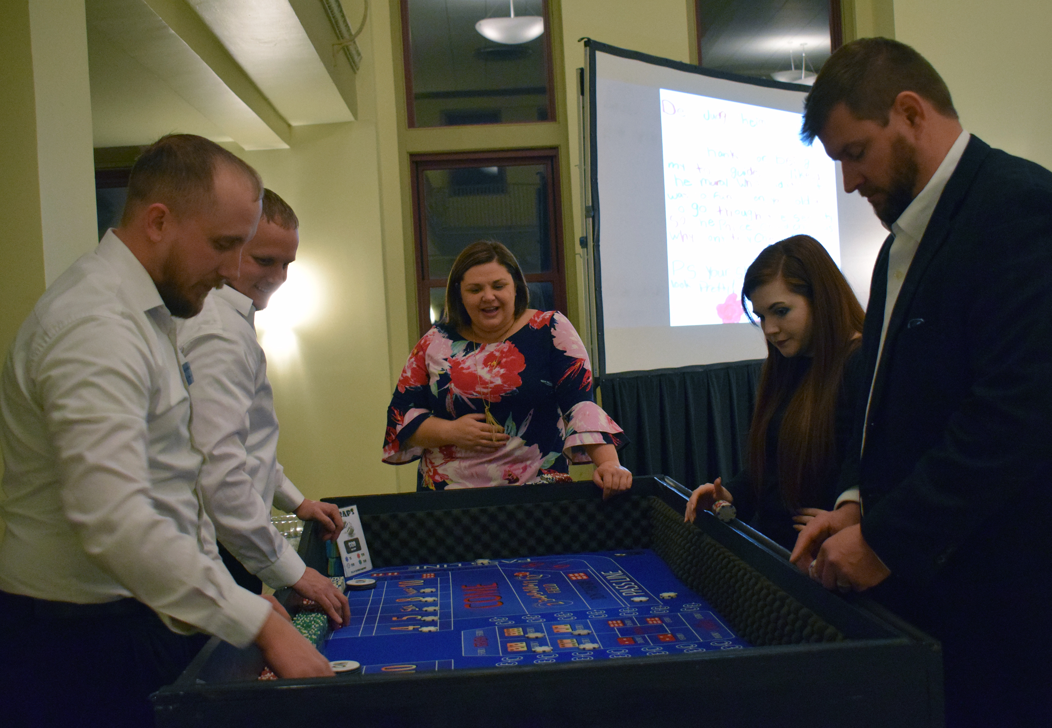 People enjoy playing craps at the Omaha Law League Casino Night at the Livestock Exchange Building on March 6, 2020. (Photo by Elizabeth A. Elliott)