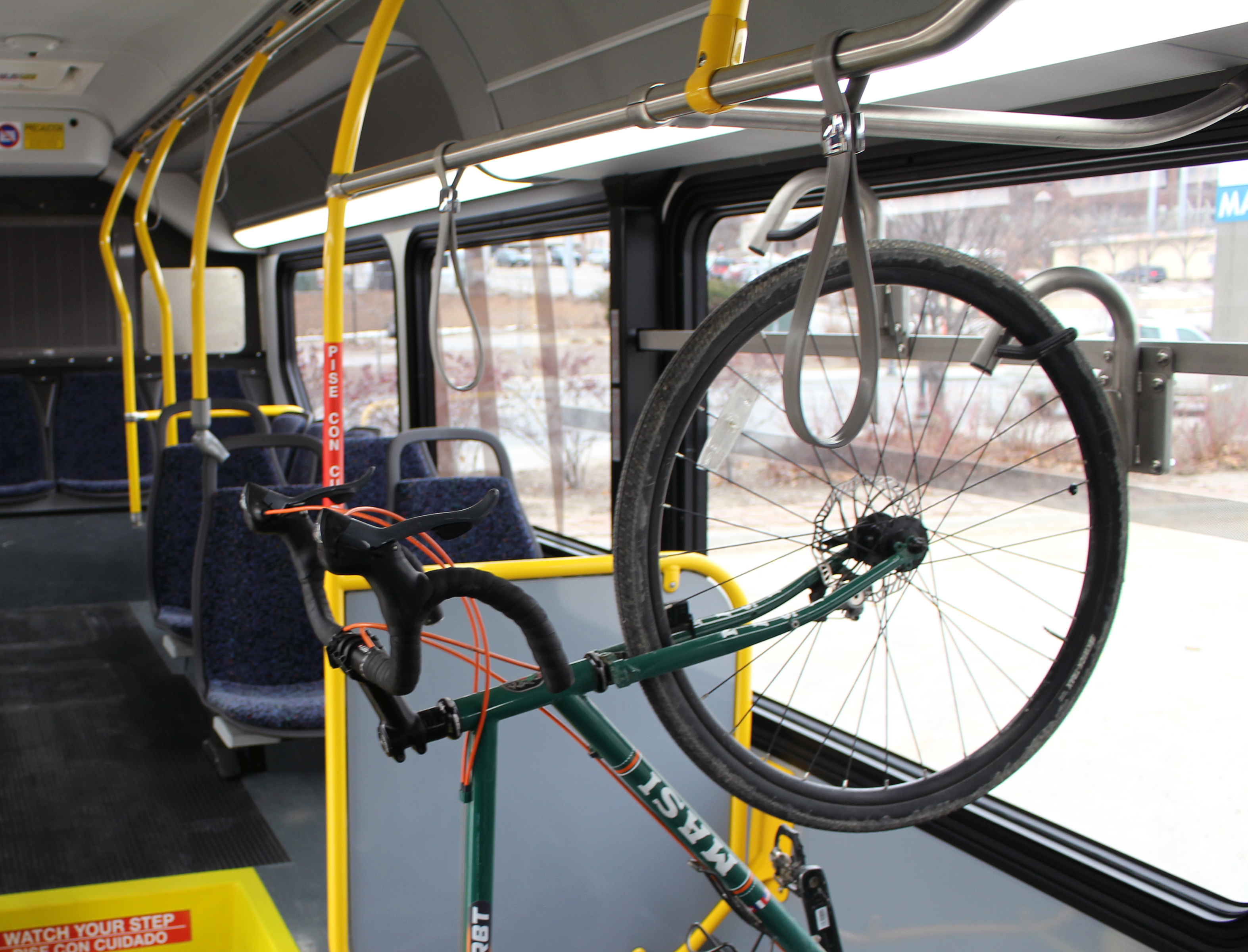 A bicycle hangs on a rack inside of one of a new ORBT bus. (Photo by Scott Stewart)