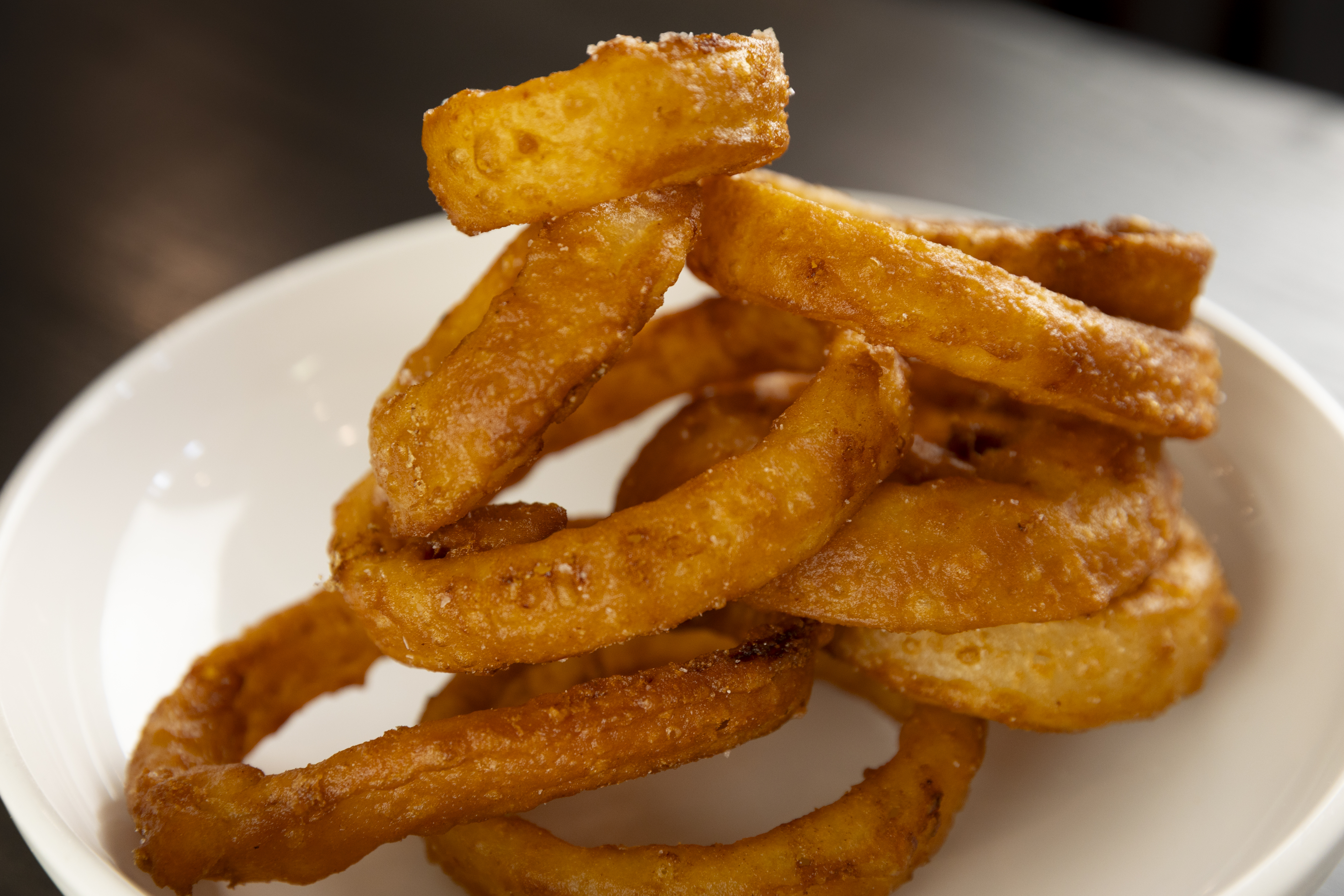 The Ruhlman’s onion rings, which Sarah Baker Hansen says are uber crispy and some of the tastiest she has tried during her tour of steakhouses this year. She liked a homemade ranch dressing for dipping, which tasted of black pepper and black garlic.<br />(Ryan Soderlin / Flatwater Free Press)