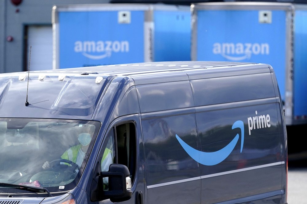 An Amazon Prime logo appears on the side of a delivery van as it departs an Amazon Warehouse location, Oct. 1, 2020, in Dedham, Mass. (AP)