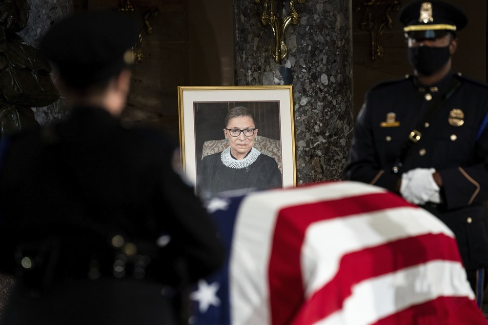 The flag-draped casket of Justice Ruth Bader Ginsburg lies in state in the U.S. Capitol on Friday, Sept. 25, 2020. Ginsburg died at the age of 87 on Sept. 18 and is the first women to lie in state at the Capitol. (Erin Schaff/ New York Times via AP)