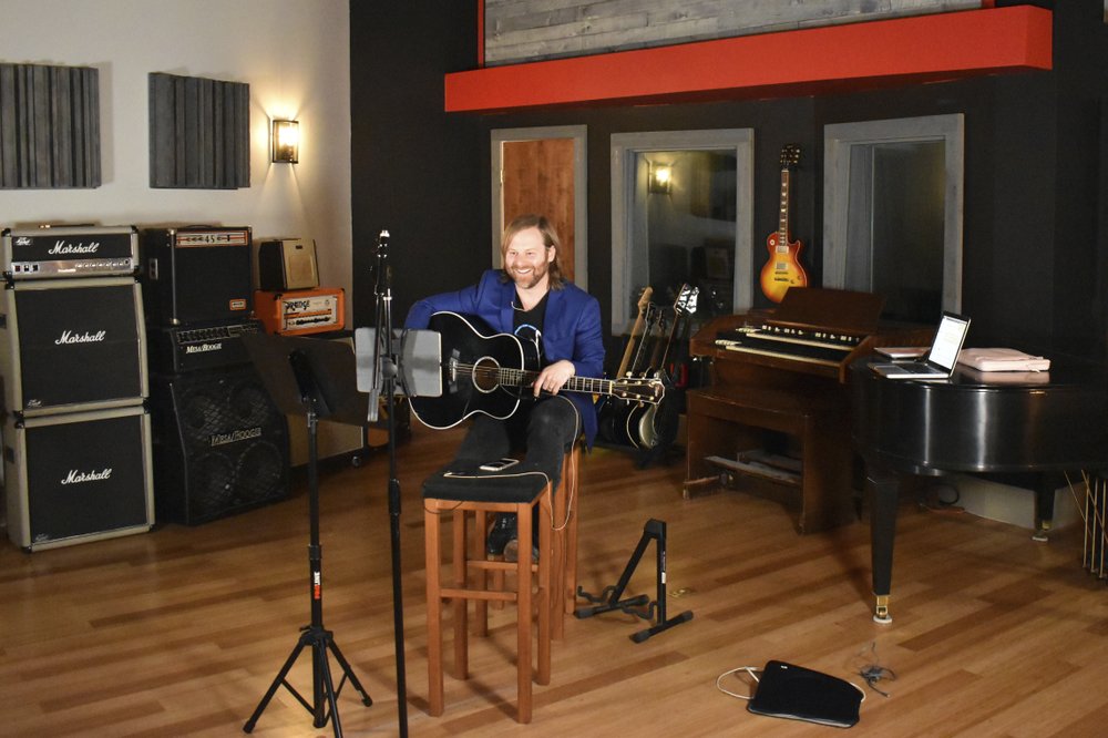 Benji Harris, an artist/songwriter and client executive for a company called Song Division, leads a virtual songwriting team building workshop for a corporate client at The Record Shop, a recording studio in Nashville, Tenn., owned by Sean Giovanni, on March 31, 2020. Giovanni got an important lesson that will help his business long after the pandemic has subsided. The Record Shop doesn’t have to be limited to what it can produce onsite. (Sean Giovanni via AP)