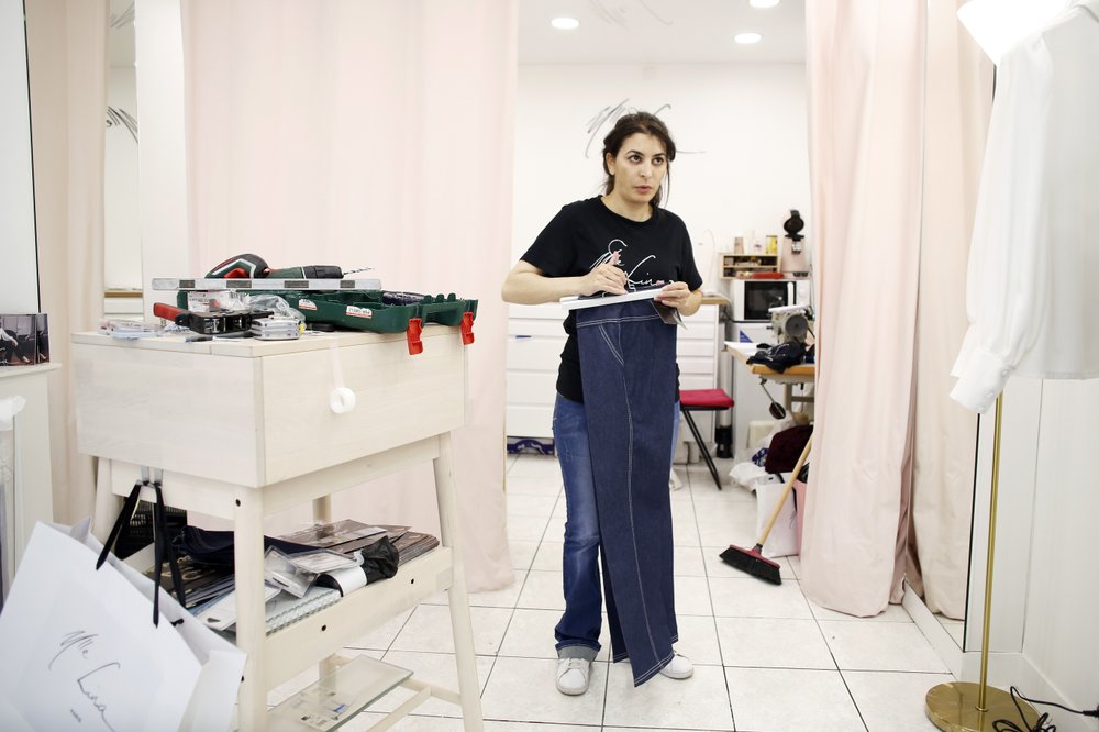 Dressmaker Lina Mokrane puts a trouser on a clothes rail during the new arrangement of her shop in Paris on Wednesday, June 17, 2020. Mokrane spent France’s two-month shutdown trying to come up with ideas for keeping her Paris boutique going, knowing that when she reopened, established customers likely wouldn’t be shopping. She has come up with a series of plans, beginning with an open house this weekend to bring in people from the neighborhood. (AP)