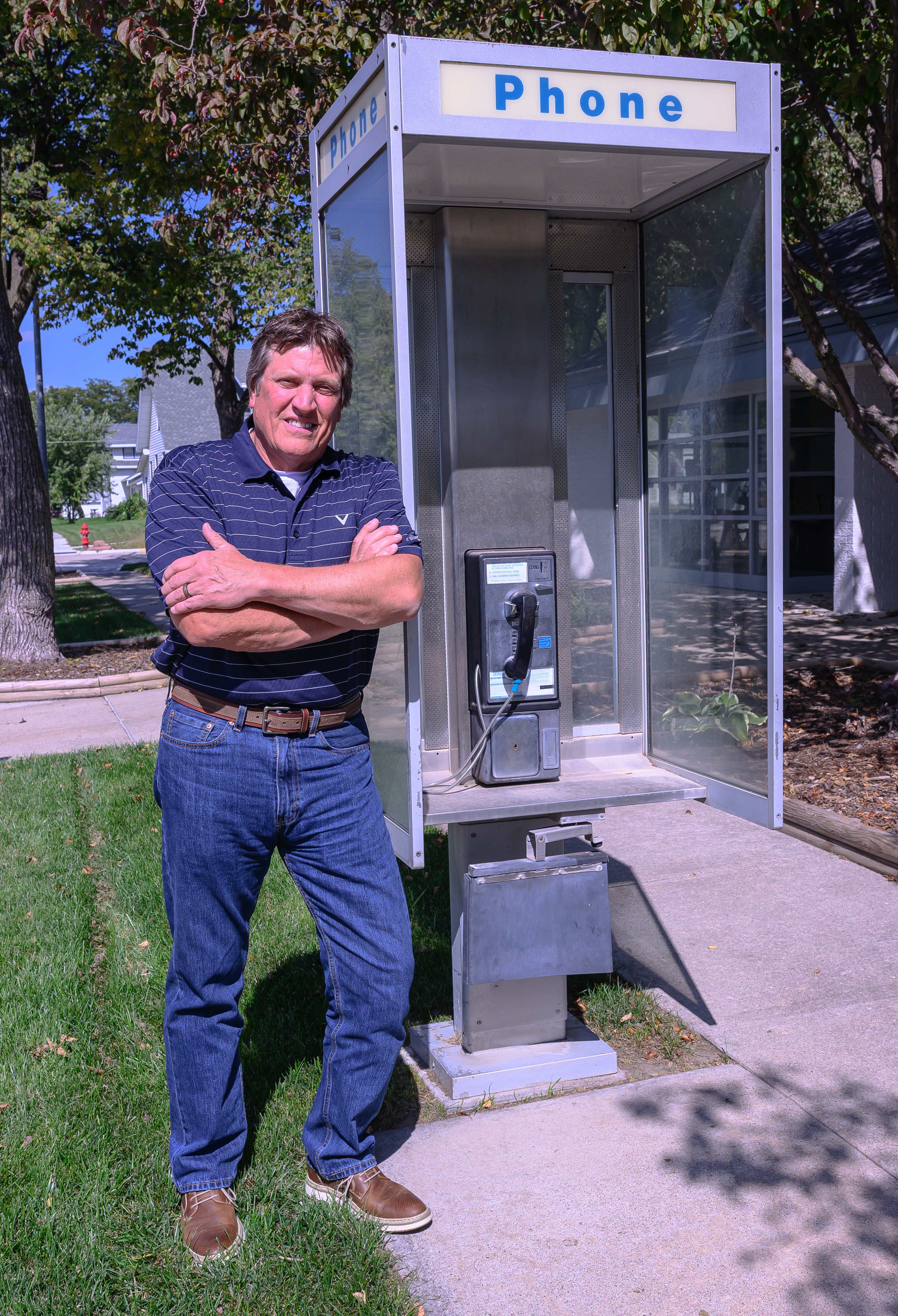 Curiosity led Dr. Lane Handke to try the pay phone outside the Pierce Telephone Co. in Pierce. He asked Jeff Kesting, the phone company’s plant manager, why it wasn’t working. Kesting fixed the problem and encouraged Handke to try again. The pay phone is one of only 81 still in operation in Nebraska.<br />(Darin Epperly / Flatwater Free Press)