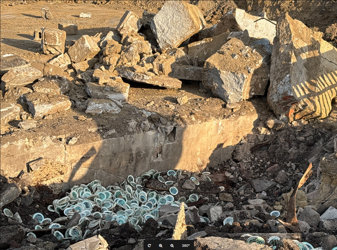 Lids for ice cream containers spilled out of a vault-like structure that a backhoe machine hit while preparing the Oxworth Apartments site.<br />(Courtesy of Hausmann Construction)