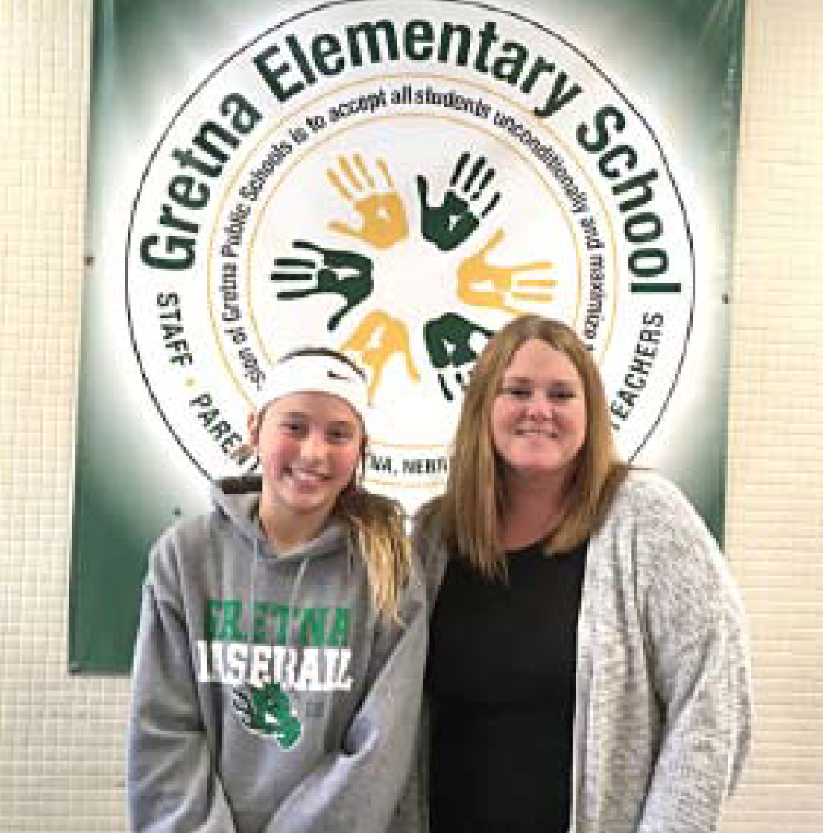Gretna Elementary School fifth-grader Ellie Melton earns the congratulations of her<br />teacher, Stephanie Bartram, on her first place win in the Poster Contest. Ellie’s parents<br />are Charlie and Andi Melton. Her poster is on a billboard near 78th and Dodge Streets. (Photo by Lorraine Boyd)
