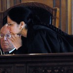 Nebraska Supreme Court justices Edward Hannon and Lindsey Miller-Lerman look over shared evidence during the Hergert impeachment trial in the Nebraska Supreme Court, Thursday, May 11, 2006, in Lincoln, Neb. University of Nebraska Regent David Hergert was called by prosecutors to testify Thursday in his impeachment trial. 
(Robert Becker / The Lincoln Journal Star / AP Photo)