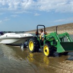 Tower Harbor Marina owner Bill Barrow uses a tractor on a newly made rock boat ramp to lower Doug Vollmers boat Thursday afternoon, Aug. 31, 2006, into Kanopolis Reservoir in Kanopolis, Kan. 
(Sandra J. Milburn / The Hutchinson News via AP )