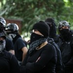 Antifa members gather at a rally held by Patriot Prayer in Portland, Ore., on Saturday, June 30, 2018. Police dispersed clashing protesters as problems occurred when the two opposing protest groups — Patriot Prayer and antifa — took to the streets.
(Mark Graves / The Oregonian via AP)