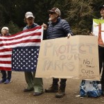 Demonstrators hold signs in protest of the Trump administration's firing of National Park Service employees at Muir Woods National Monument in Marin County, Calif., Saturday, March 1, 2025. 
(Santiago Mejia / San Francisco Chronicle via AP)