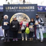 Masako Higuchi, 83 (center) and May DuBois (second from right) take photos with fellow runners ahead of the Los Angeles Marathon at the Lifestyle Expo at Dodger Stadium, Friday, March 14, 2025 in Los Angeles. 
(Damian Dovarganes / AP Photo)