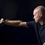 This undated photo provided by Centivax in 2025 shows Tim Friede, who is hyper-immune to the venom of various snakes, with a water cobra wrapped around his arm. 
(Centivax via AP)