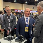 Berkshire Hathaway Vice Chairman Greg Abel (center) checks out the flight simulators offered by one of Berkshires companies, Flight Safety as he toured the exhibit hall Friday, May 3, 2024, in Omaha, Neb. ahead of Saturday's meeting. 
(Josh Funk / AP Photo)