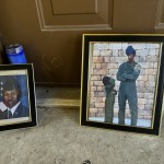 Candles and framed photos of Roger Fortson, a U.S. Air Force senior airman who was fatally shot by a Fla. sheriff's deputy on May 3, 2024, sit in the doorway of the apartment where he was killed in Fort Walton Beach, Fla., on Aug. 23. 
(Kate Payne / AP Photo)