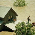 A family moves belongings out of a second floor window of a farm house to a waiting boat near Bristol, T.X., in Ellis County on Saturday, May 5, 1990.
(Pat Sullivan / AP Photo)
