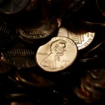A lone penny is illuminated in a bin of completed pennies at the U.S. Mint in Denver on Aug. 15, 2007.
(David Zalubowski / AP Photo)