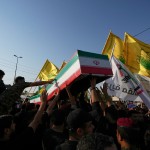 Mourners carry the coffin of an Iranian adviser draped in the Iranian flag during a group funeral for Iranian advisers and Popular Mobilization Forces fighters killed in airstrikes on bases belonging to Iraq's Popular Mobilization Forces, a coalition of predominantly Shiite militias that includes Iran-backed groups, in Mosul, Iraq, Wednesday, July 29, 2026.
(Hadi Mizban / AP Photo)