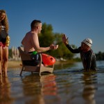 Ukrainian war veteran Maxim Yuzvyak (center) is greeted by sport celebrity Danylo Sapunov during a sporting event to encourage people and injured soldiers to take part in sports at a lake on the outskirts of Kyiv, Monday, Aug. 24, 2026.
(Francisco Seco / AP Photo)