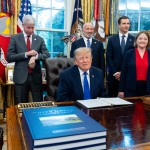 President Donald Trump winks as the members of the media depart the Oval Office of the White House as Essar Capital Director Prashant Ruia, from left: Energy Secretary Chris Wright, Commerce Secretary Howard Lutnick, John Jovanovic, chairman of the Export-Import Bank of the United States, Iowa Attorney General Brenna Bird, Mariannette Miller-Meeks, R-Iowa., and Rep. Ashley Hinson, R-Iowa, look on, Monday, Sept. 28, 2026, in Washington. 
(Alex Brandon / AP Photo)