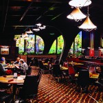 The dining room at Johnny’s Cafe in Omaha. The interior of the restaurant dates from a remodel in the early 1970s, including the now-iconic backlit landscape mural on the dining room’s south wall. 
(Joshua Foo / Flatwater Free Press)