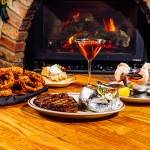 Everything we tried at The Drover during our Steak Town visit included (clockwise from left) onion rings, cinnamon toffee cheesecake, a Manhattan cocktail, shrimp cocktail, a loaded baked potato and a ribeye.
(Joshua Foo / Flatwater Free Press)