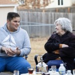 Zak Abughalyoon, 19 (left) and St. Pius X Catholic Church of Omaha parishioner Rosie Volkmer chat over tea outside the Abughalyoon family home in Papillion on Wednesday, Feb. 26, 2025.  "The U.S. made a promise to them,” said another St. Pius parishioner. “And we broke our promise." 
(Rebecca S. Gratz / Flatwater Free Press)