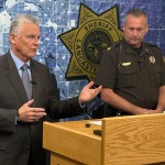 Lancaster County Attorney Pat Condon (left) and Lancaster County Sheriff Chief Deputy Ben Houchin announce criminal charges and arrests of five out-of-state individuals who helped circulate petitions for three petitions in Nebraska’s capital city at a news briefing Aug. 7, 2026, in Lincoln, Nebraska.
(Zach Wendling / Nebraska Examiner)