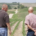 Stanton County landowner Justin Kennedy (left) speaks with a court-appointed appraiser as they look over land where the Nebraska Public Power District is taking an easement by eminent domain for a new transmission line. Kennedy said he hoped to build a home on the land someday, but those plans are now extinguished. 
(Jeremy Turley / Flatwater Free Press)