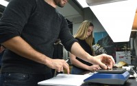 Josh Mott (left) and Hannah Pilkey label, weigh and bag genetically modified chestnuts in a lab at the State University of New York's College of Environmental Science & Forestry in Syracuse, N.Y., Monday, Sept. 30, 2019. The ESF American Chestnut Research & Restoration Project researchers have been able to add a gene to American chestnuts that give the trees resistance to a blight that decimated the trees in the 20th century. 
(Adrian Kraus / AP Photo)