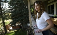 Sonia Moran looks at a meadow owned by The Rock church from her patio in Castle Rock, Colo., on Friday, July 12, 2024. The church plans were to develop affordable housing on its property, drawing the ire of some of its neighbors, including Moran. 
(Thomas Peipert / AP Photo)