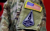 A solider wears a U.S. Space Force uniform during a ceremony for U.S. Air Force airmen transitioning to U.S. Space Force guardian designations at Travis Air Force Base, Calif., Feb. 12, 2021. 
(Noah Berger / AP Photo)