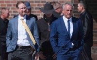 Health and Human Services Secretary Robert F. Kennedy Jr. (right) stands with Dr. Ben Edwards (left) outside the Reinlander Mennonite Church in Seminole, Texas, on Sunday, April 6, 2025, after a second measles death. 
(Annie Rice / AP Photo)