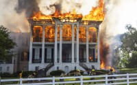 Fire crews mover a line around the now fully engulfed the Nottoway Plantation on Thursday, May 15, 2025 in White Castle, La. 
(Michael Johnson / The Advocate via AP)