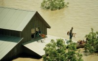 A family moves belongings out of a second floor window of a farm house to a waiting boat near Bristol, T.X., in Ellis County on Saturday, May 5, 1990. 
(Pat Sullivan / AP Photo)
