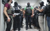 Masked federal agents wait outside an immigration courtroom, July 8, 2025, in New York. 
(Olga Fedorova / AP Photo)