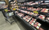 A shopper compares beef prices at a grocery store in Mount Prospect, Ill., Thursday, July 17, 2025. 
(Nam Y. Huh / AP Photo)