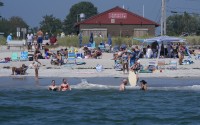 Visitors enjoy the summer weather not far from recent sightings of white sharks, Wednesday, Aug. 13, 2025, in Scarborough, Maine. 
(Robert F. Bukaty / AP Photo)