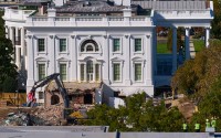 Construction workers (bottom right) atop the U.S. Treasury, watch as work continues on a largely demolished part of the East Wing of the White House, Thursday, Oct. 23, 2025, in Washington, before construction of a new ballroom. 
(Jacquelyn Martin / AP Photo)